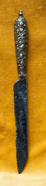 A 16th C. knife with a superbly decorated brass handle.