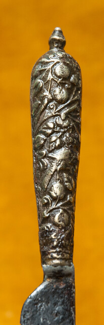 A 16th C. knife with a superbly decorated brass handle.