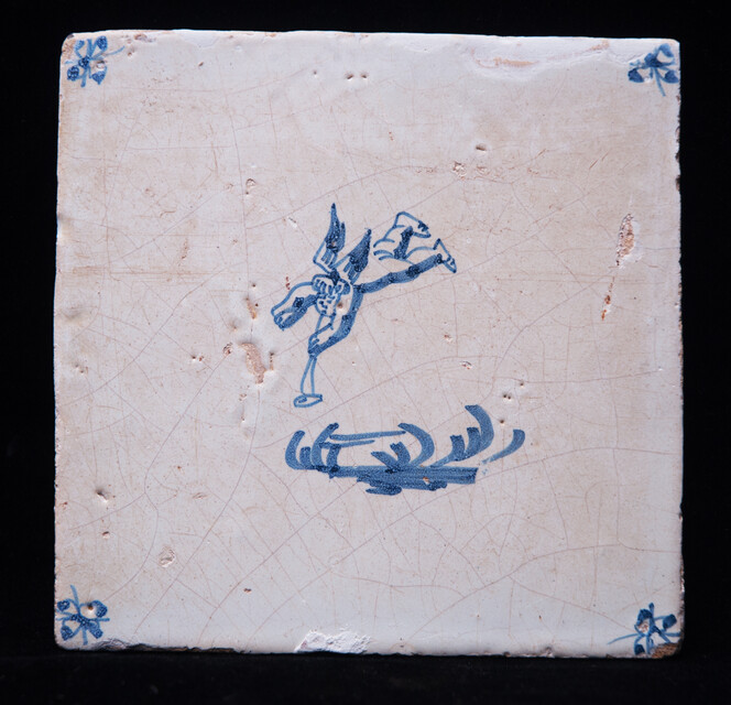 A 17th C. Delft blue tile with a falling angel.