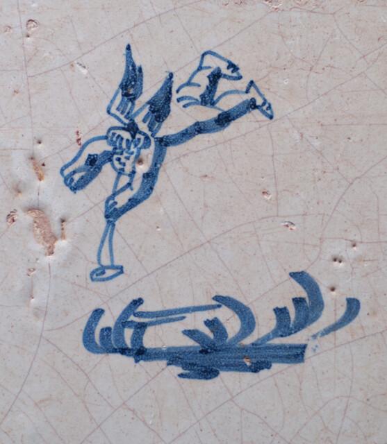 A 17th C. Delft blue tile with a falling angel.