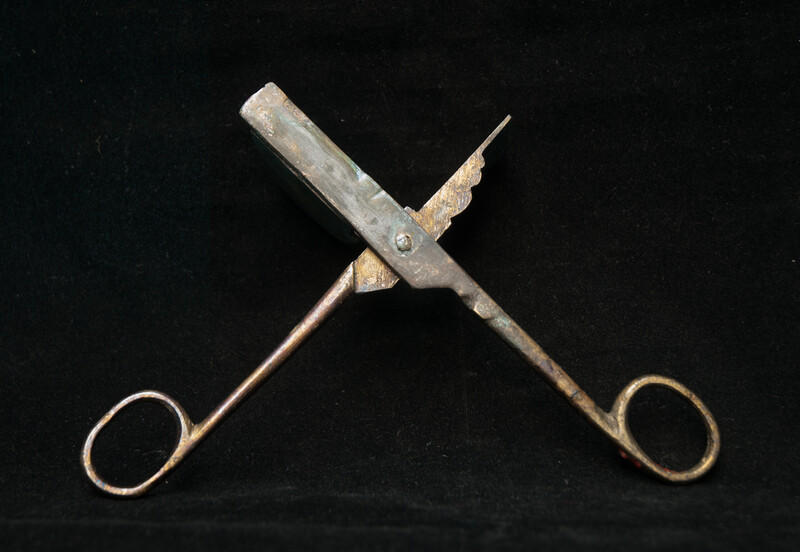 A 17th C. Dutch bronze candle snuffer.