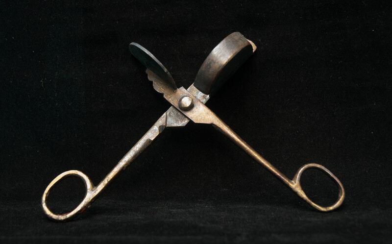 A 17th C. Dutch bronze candle snuffer.