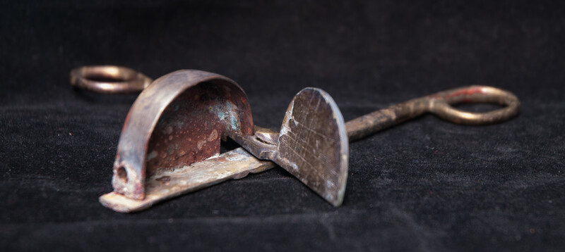 A 17th C. Dutch bronze candle snuffer.