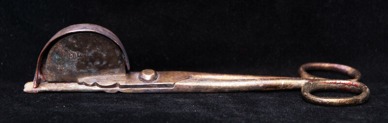 A 17th C. Dutch bronze candle snuffer.