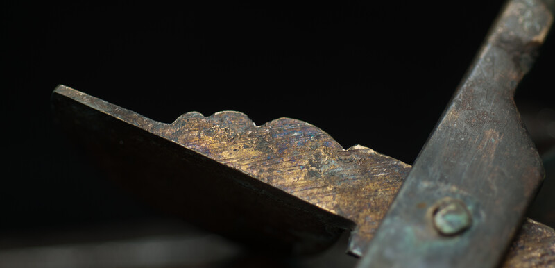 A 17th C. Dutch bronze candle snuffer.