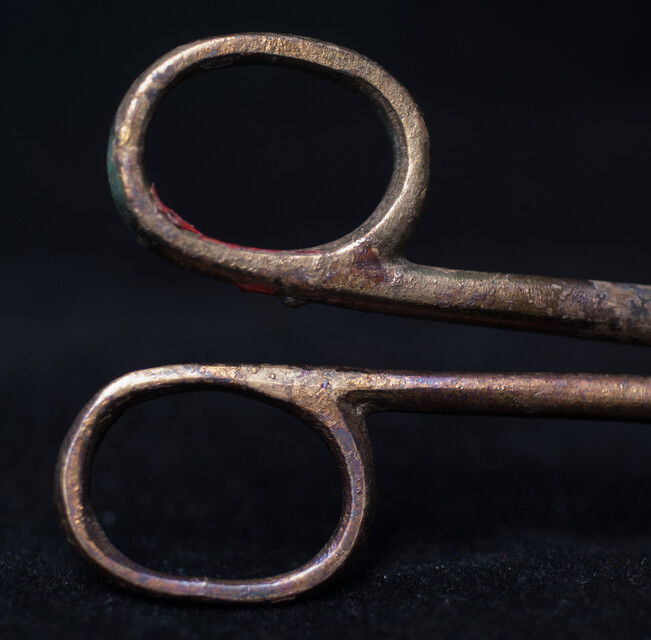 A 17th C. Dutch bronze candle snuffer.