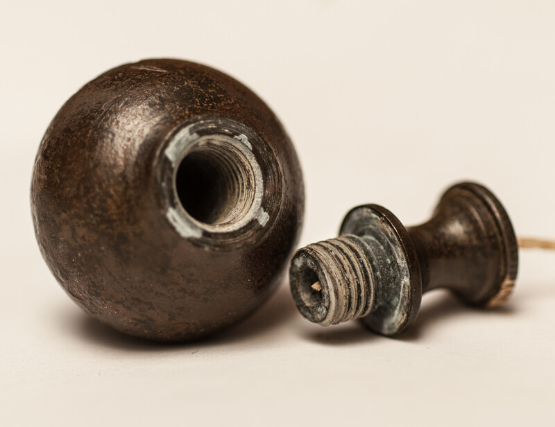 A 17th C. small bronze and iron plumb bob. 