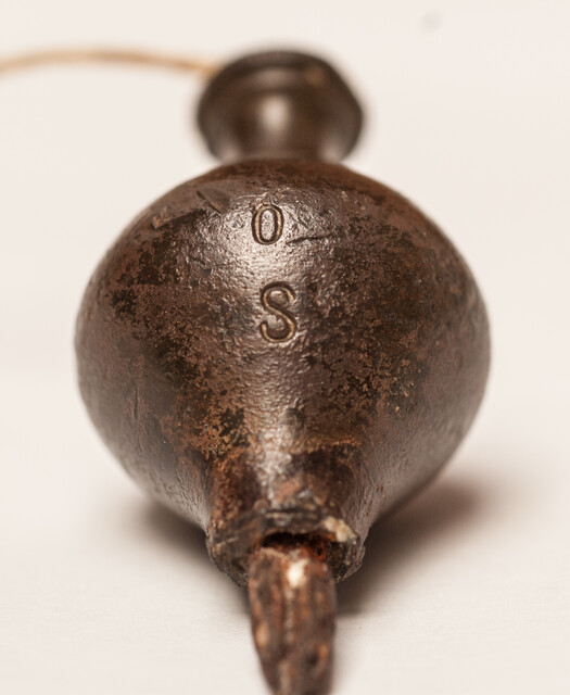 A 17th C. small bronze and iron plumb bob. 