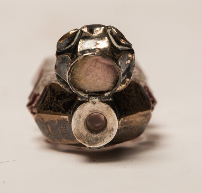 A 19th C cold enamel painted perfume bottle with a silver cap.