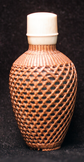 A 19th C perfume bottle covered with artful straw decoration