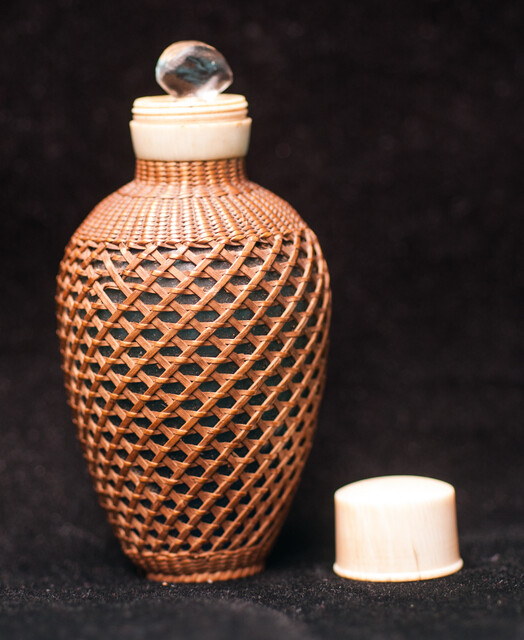 A 19th C perfume bottle covered with artful straw decoration