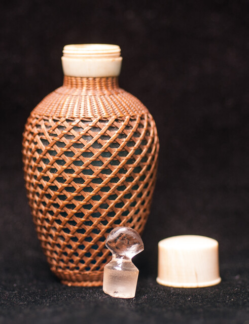 A 19th C perfume bottle covered with artful straw decoration