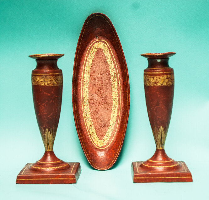 A 19th C. set of pewter candlesticks and a small oval tray, lacquered in red and gold.