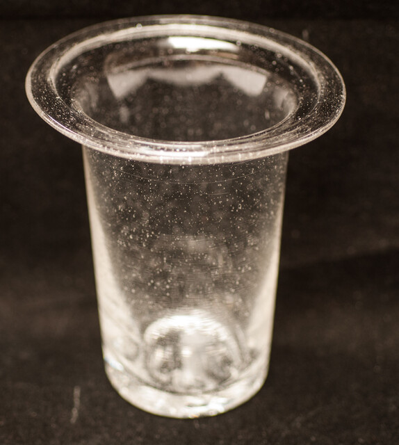 A clear eighteenth century straight glass with a folded rim and an unpolished pontil.
