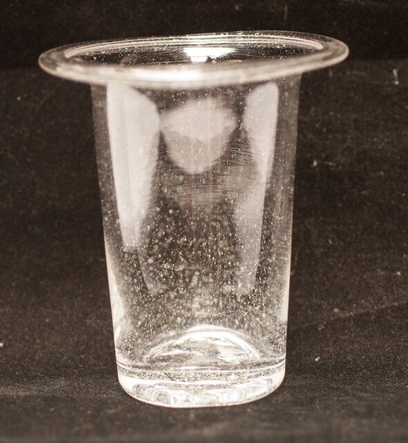 A clear eighteenth century straight glass with a folded rim and an unpolished pontil.