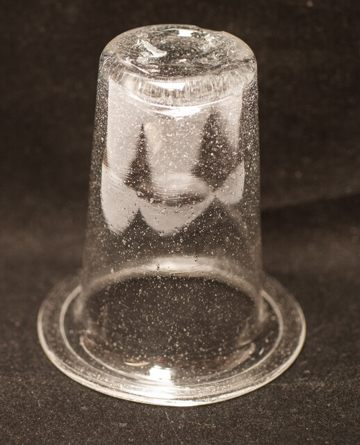 A clear eighteenth century straight glass with a folded rim and an unpolished pontil.