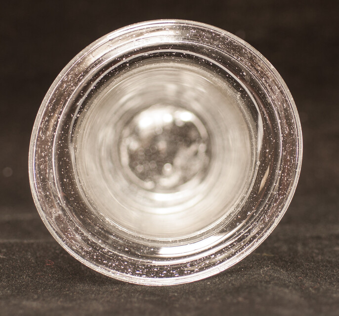A clear eighteenth century straight glass with a folded rim and an unpolished pontil.