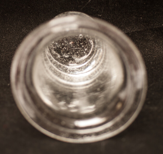 A clear eighteenth century straight glass with a folded rim and an unpolished pontil.