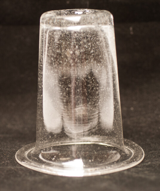 A clear eighteenth century straight glass with a folded rim and an unpolished pontil.