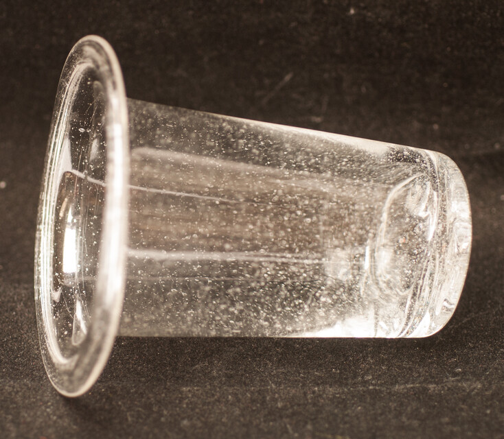 A clear eighteenth century straight glass with a folded rim and an unpolished pontil.