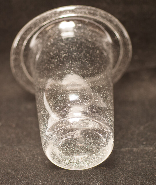 A clear eighteenth century straight glass with a folded rim and an unpolished pontil.