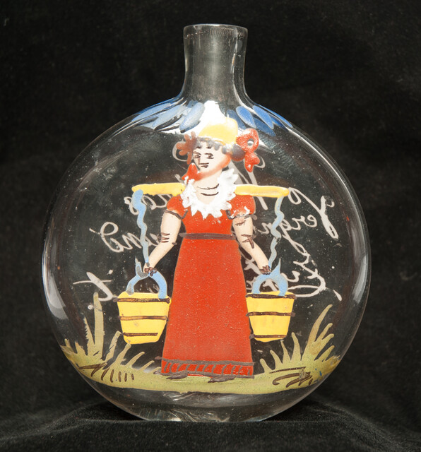 A cold enamel painted  19th C. Bohemian bottle with a milk-maid and a pleasant text.