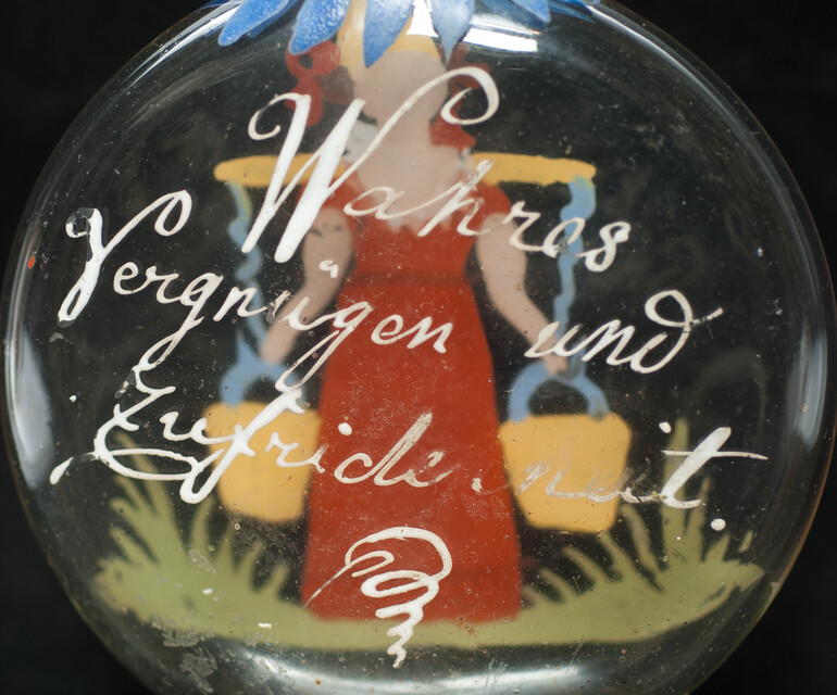 A cold enamel painted  19th C. Bohemian bottle with a milk-maid and a pleasant text.