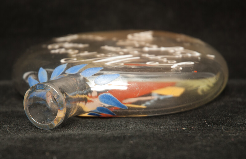 A cold enamel painted  19th C. Bohemian bottle with a milk-maid and a pleasant text.