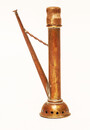 A copper toy window spout with a wooden stamper.