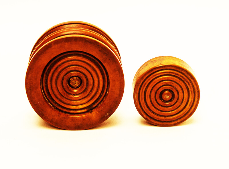 A Dutch boxwood lidded tinderbox with fire iron.