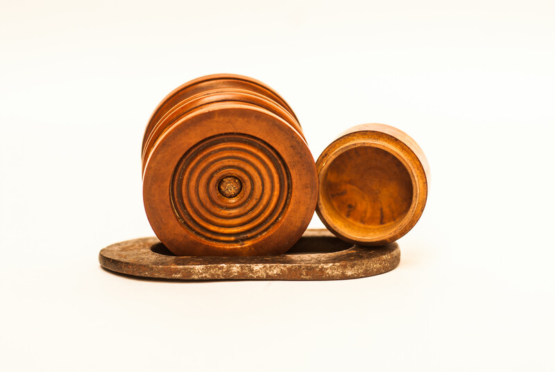 A Dutch boxwood lidded tinderbox with fire iron.