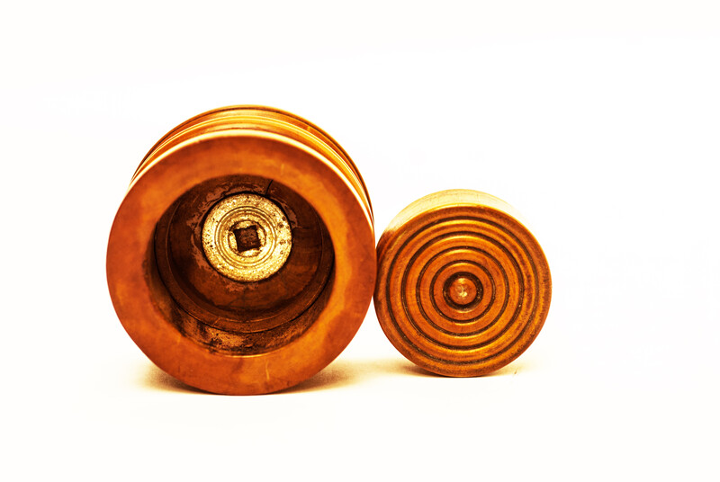 A Dutch boxwood lidded tinderbox with fire iron.