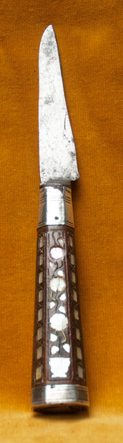 A Dutch knife with silver mountings  and mother of pearl decoration in its leather sheath dated 1776.