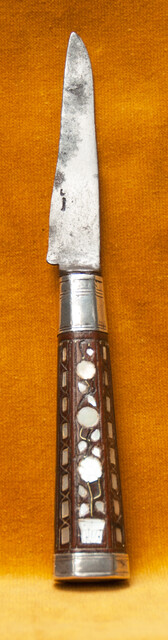 A Dutch knife with silver mountings  and mother of pearl decoration in its leather sheath dated 1776.