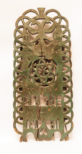 A Dutch spoonrack with 12 pewter spoons and dated 