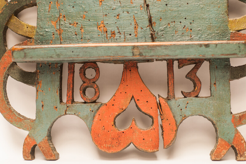 A Dutch spoonrack with 12 pewter spoons and dated 