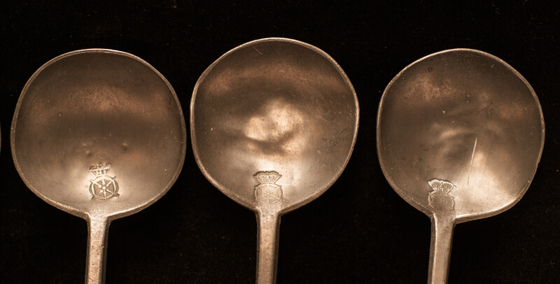 A Dutch spoonrack with 12 pewter spoons and dated 