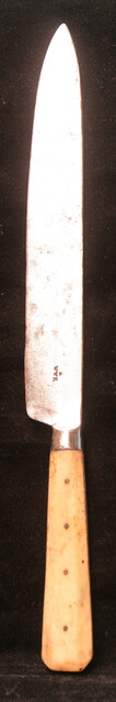 A large knife with a bone handle.