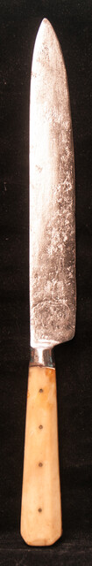 A large knife with a bone handle.