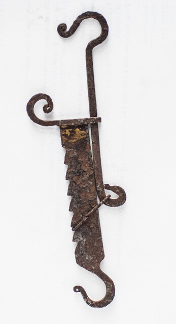 A miniature 17th C. iron toy fire pull.