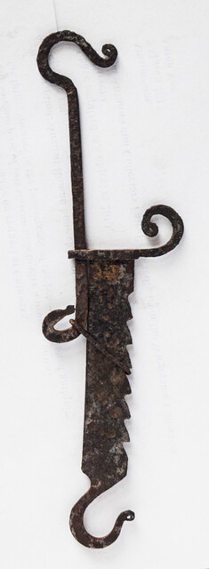 A miniature 17th C. iron toy fire pull.