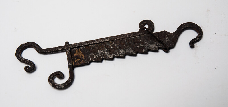 A miniature 17th C. iron toy fire pull.