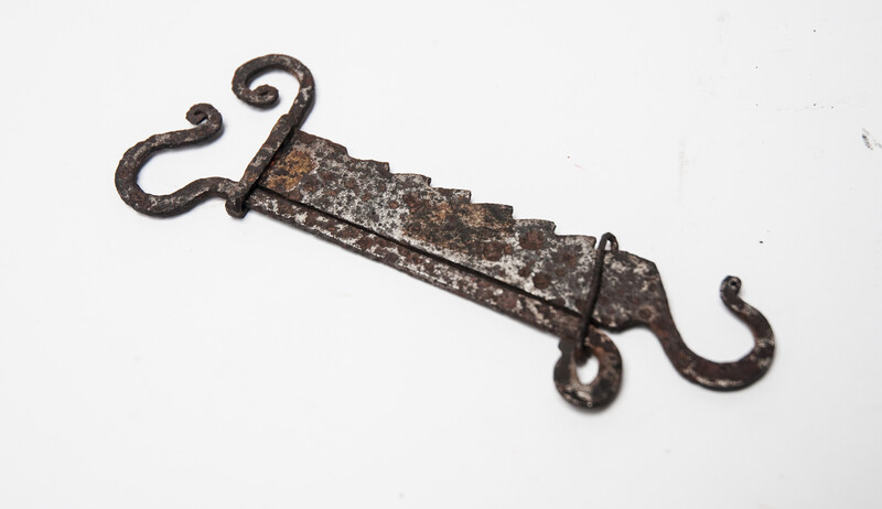 A miniature 17th C. iron toy fire pull.