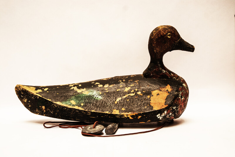 A nineteenth century Dutch wooden decoy duck with lead weights.