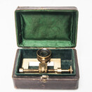 A nineteenth century precision enlarging device in its original leather covered and with green velvet lined box.