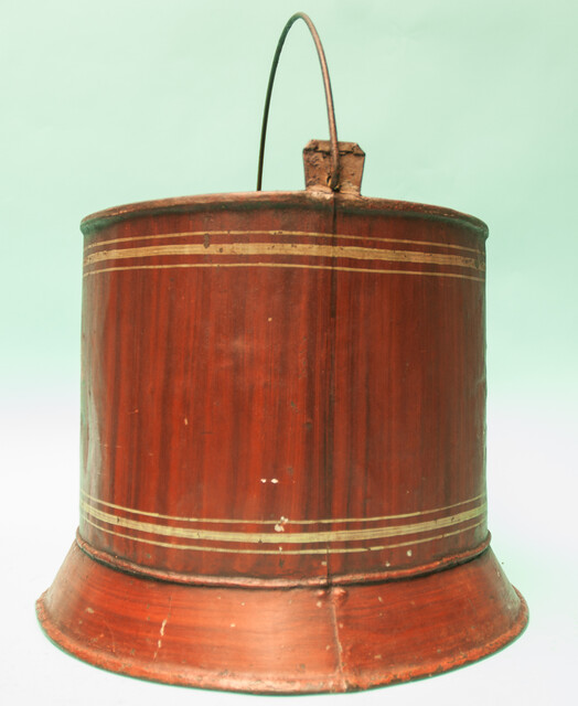 A painted metal bucket, possibly a wine-cooler.