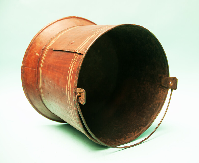 A painted metal bucket, possibly a wine-cooler.