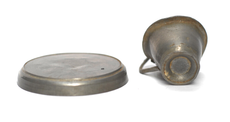 A pewter toy tea service consisting of six cup and saucers.