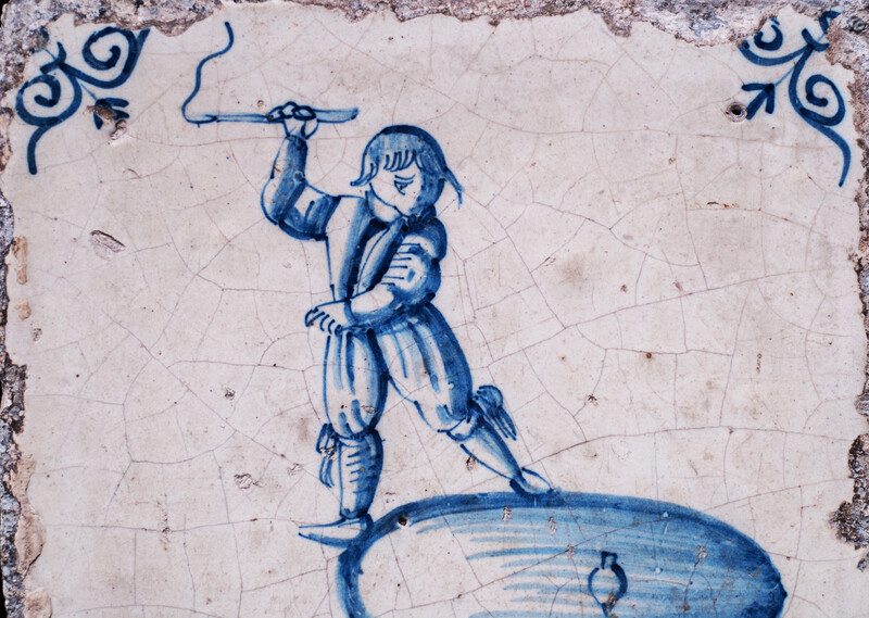 A rare early seventeenth century Delft blue tile with a boy whipping a top.