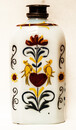 A rare eightteenth century opaline Bohemian bottle with cold enamel painting of flowers and a heart with two doves. With original pewter screw on top.